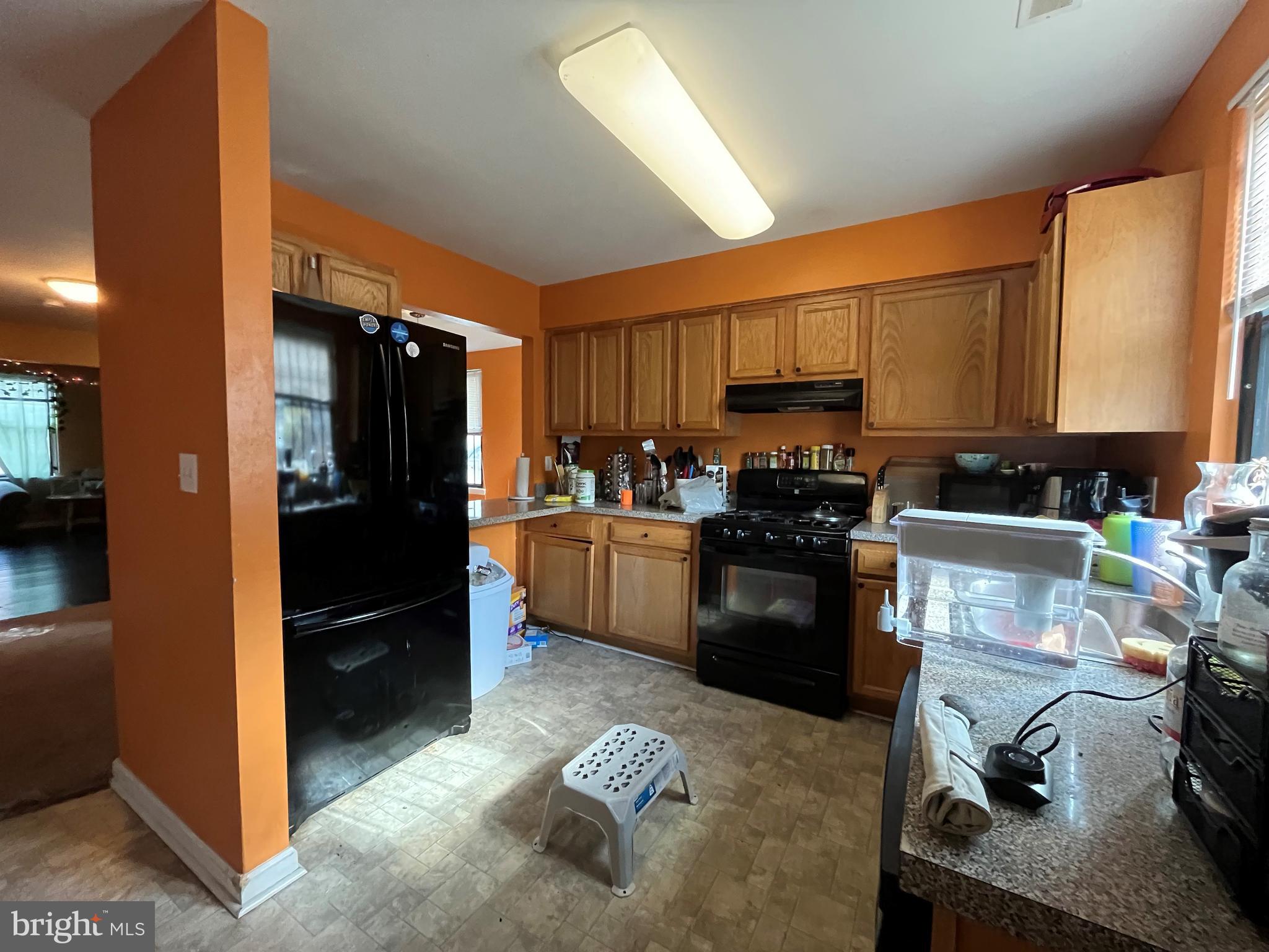 a kitchen with a refrigerator and a stove