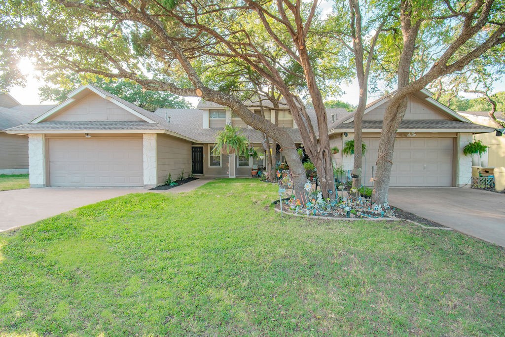 a front view of house with yard and green space