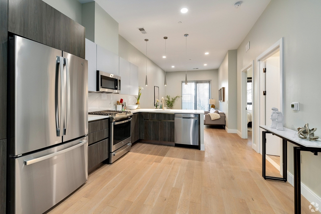 a kitchen with stainless steel appliances a refrigerator stove microwave and cabinets