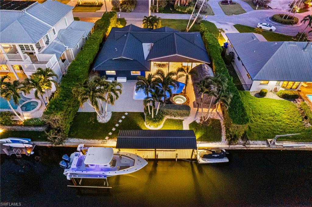 an aerial view of a house with swimming pool patio and outdoor seating