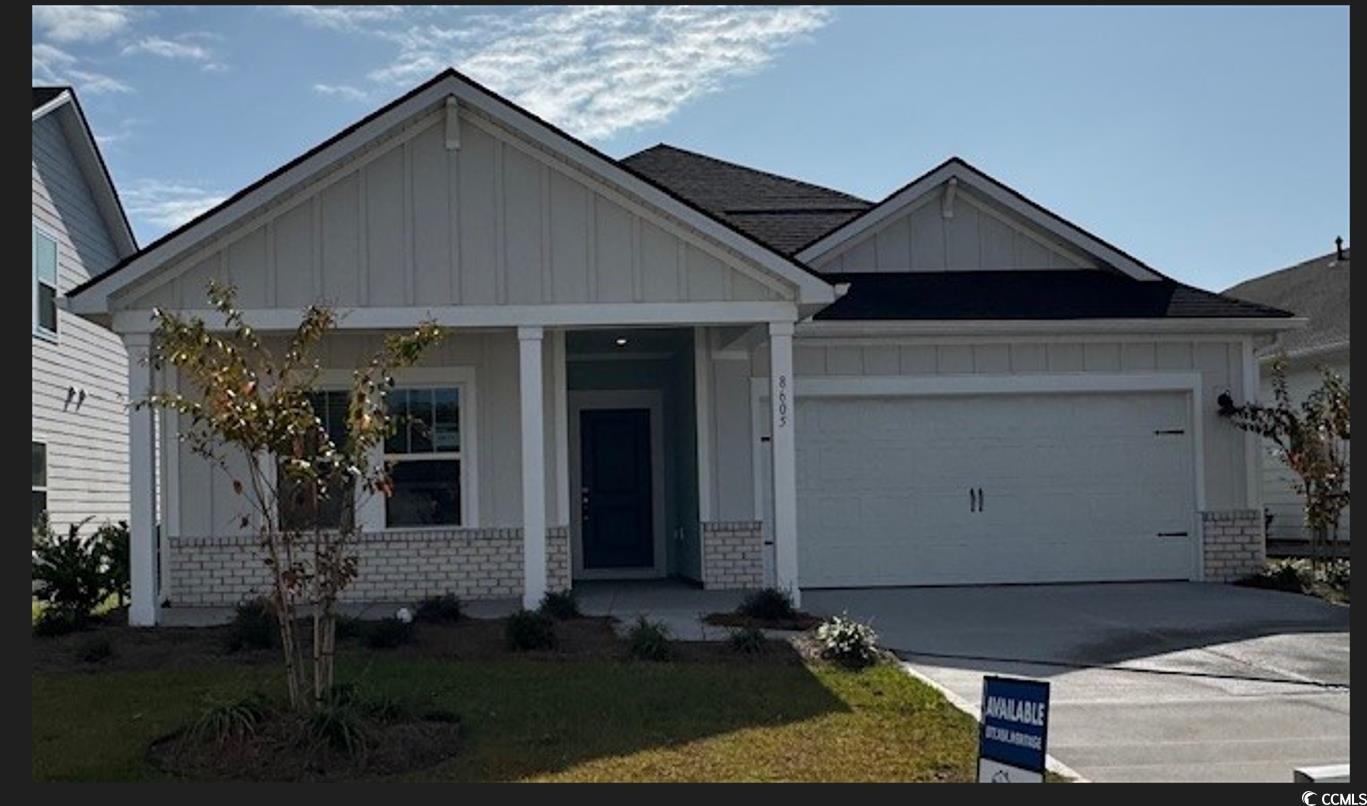 View of front of property with a front yard, a por