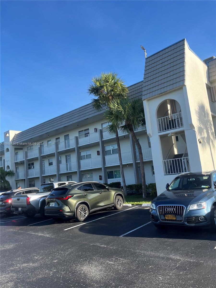 a front view of a house with parking space