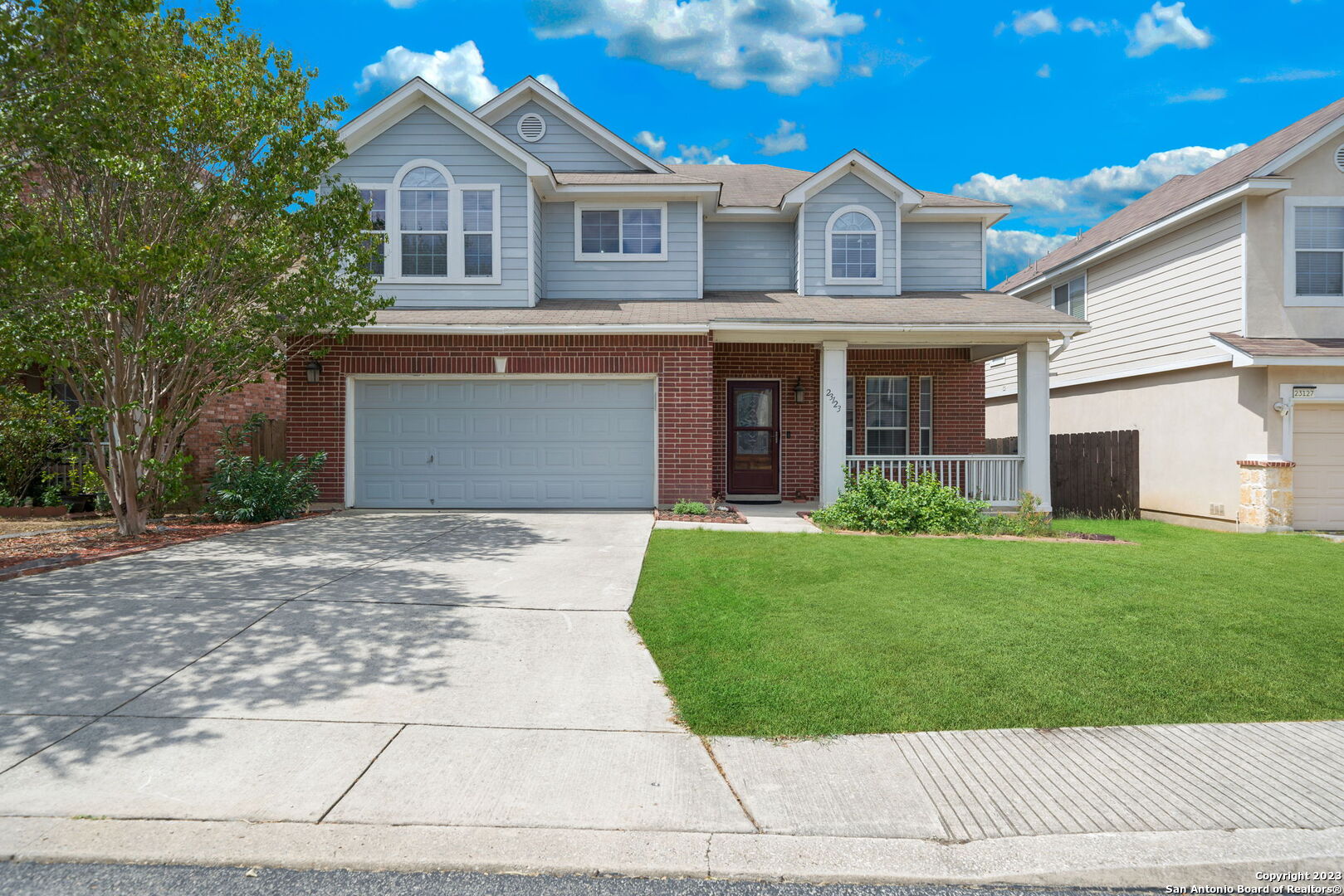 a front view of a house with a yard and garage