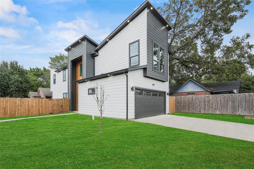 a view of a yard in front view of a house