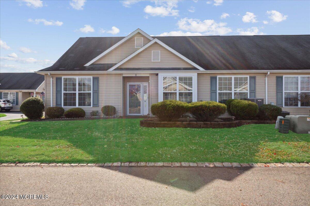 a front view of a house with a garden