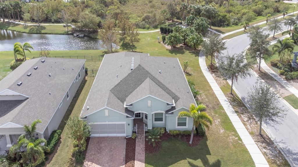 an aerial view of a house with a lake view