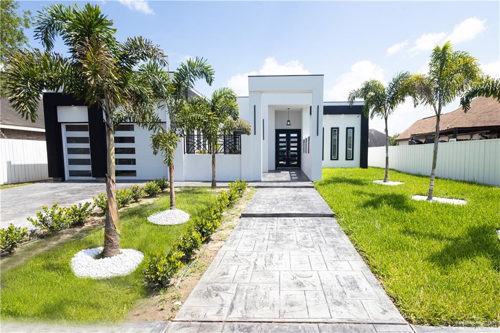 View of front of home with a garage and a front yard