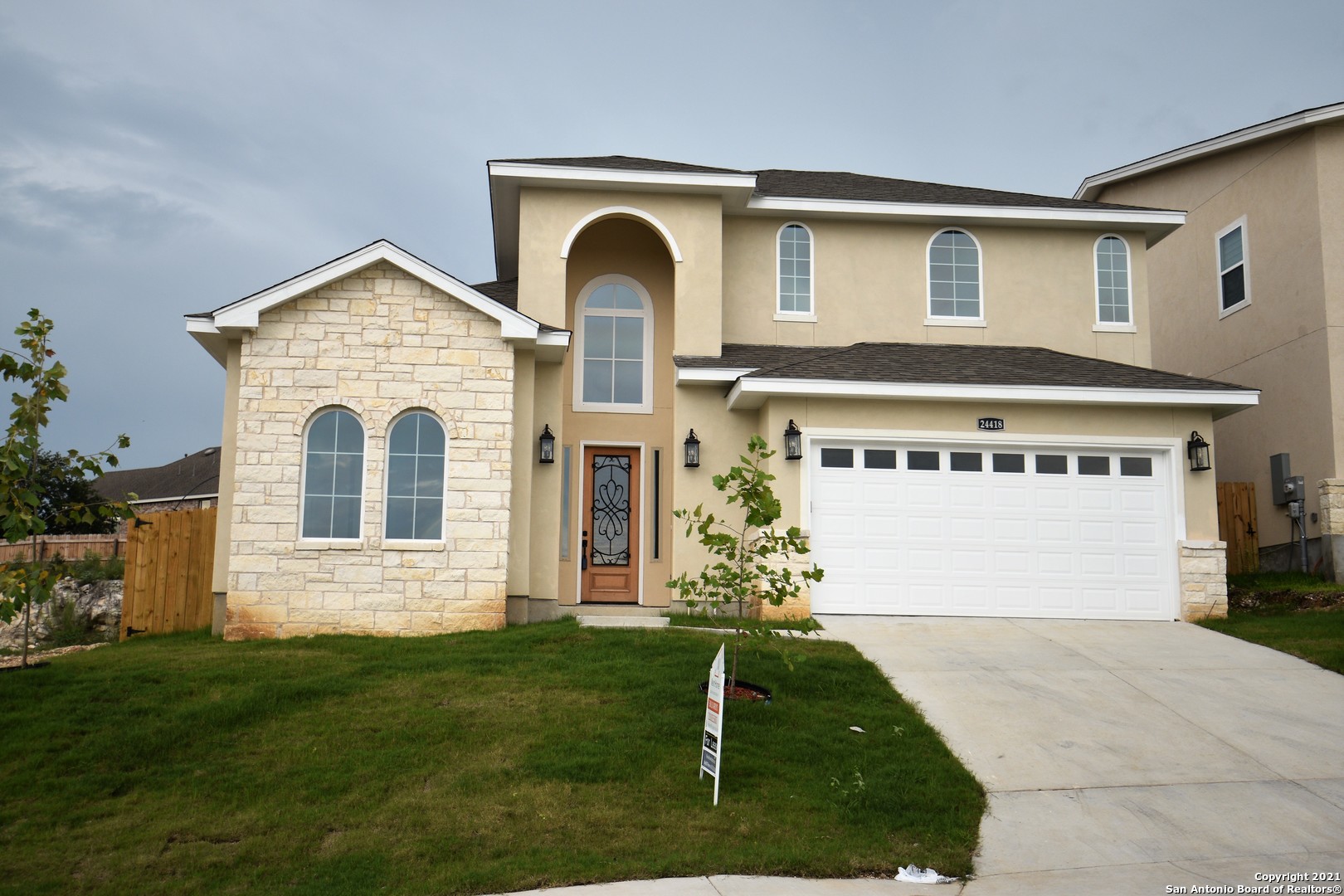 a front view of a house with a yard and garage