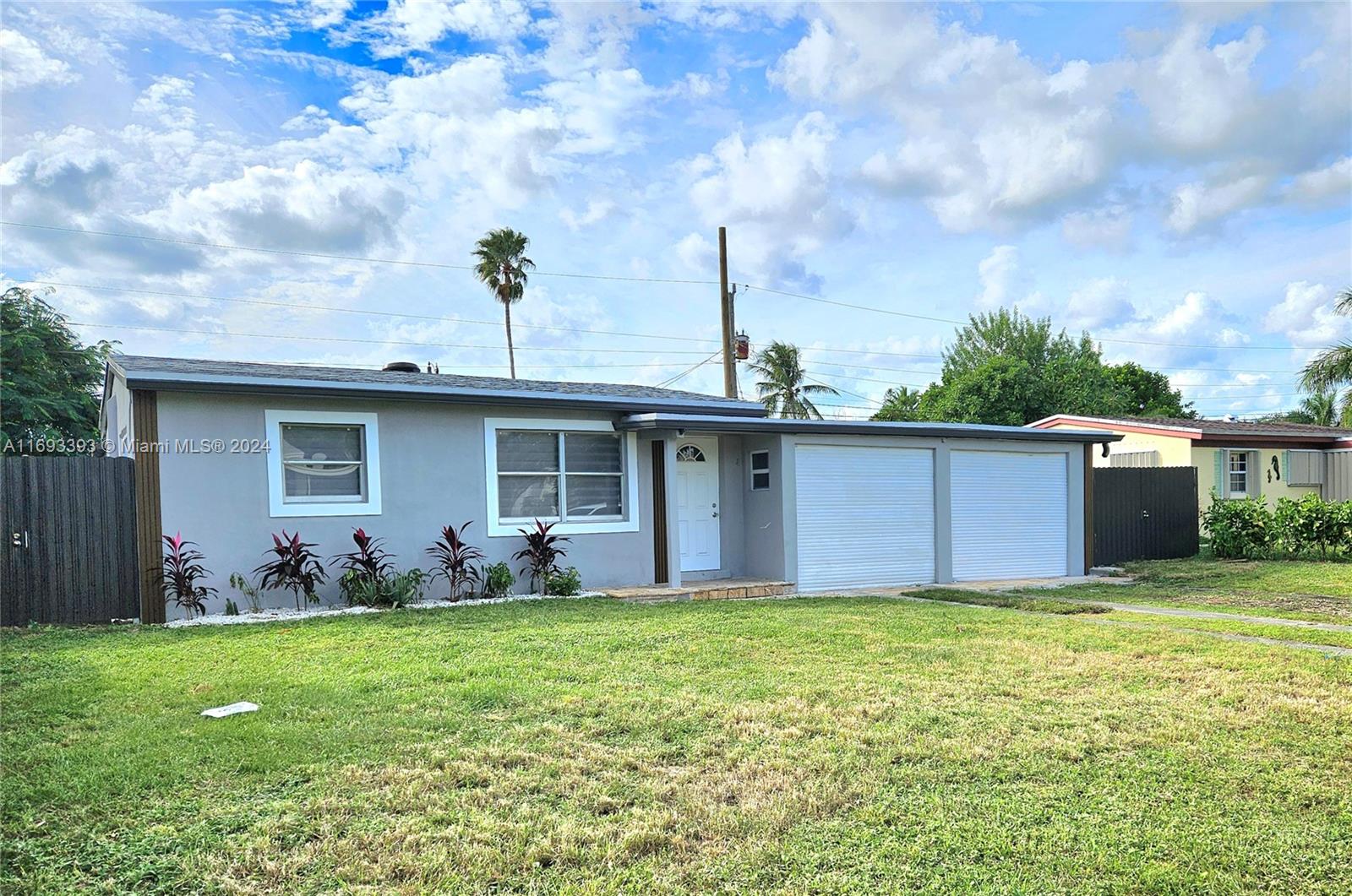 a view of a house with yard and a tree