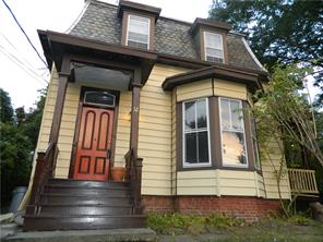 This adorable 3 bedroom, Victorian colonial has a rocking chair side porch and gingerbread details