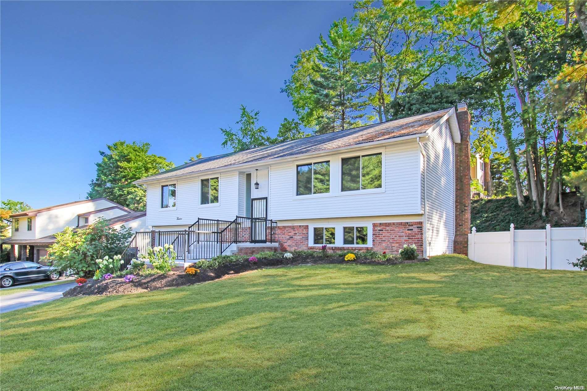 a front view of house with yard and outdoor seating