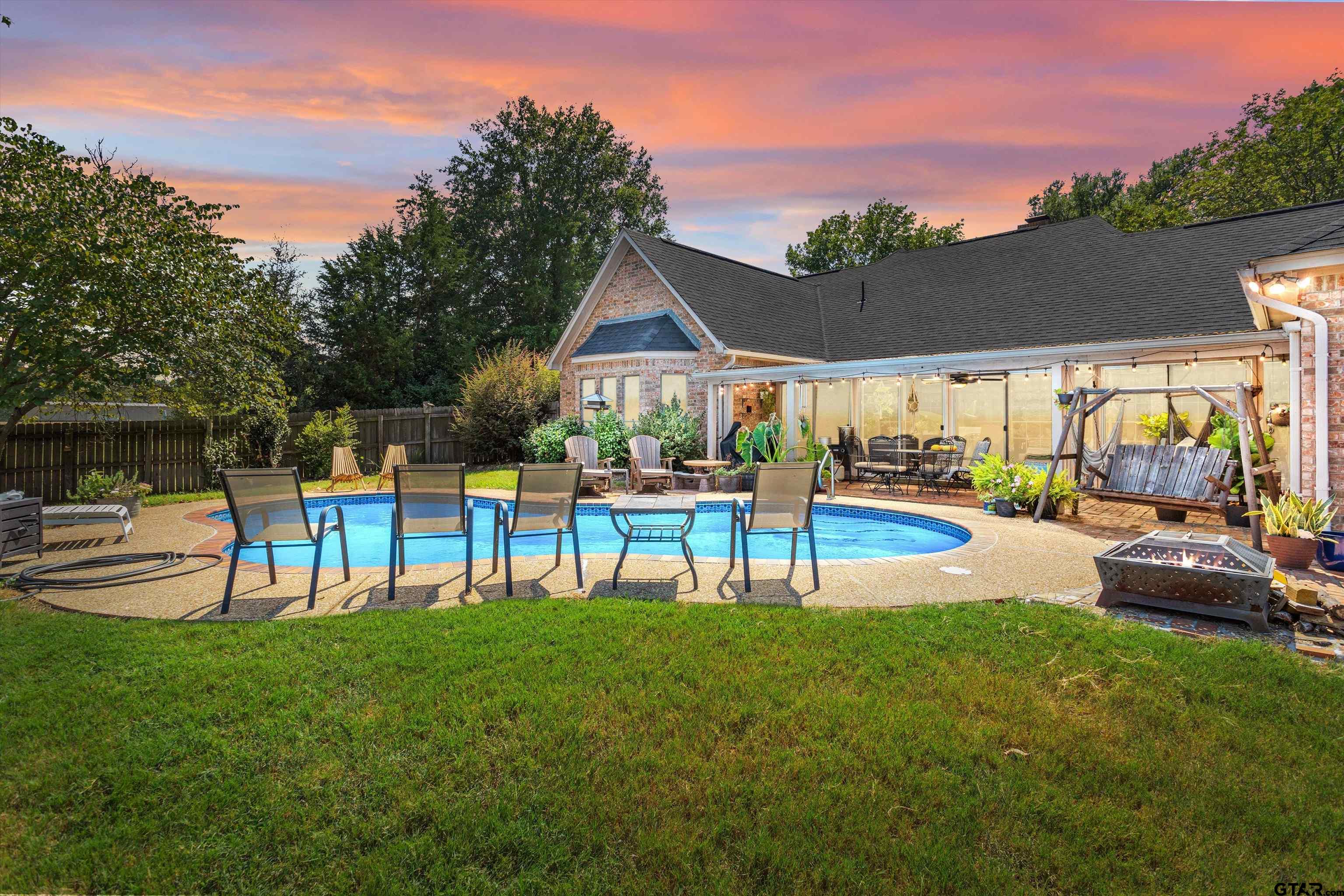 a view of a house with swimming pool and a big yard