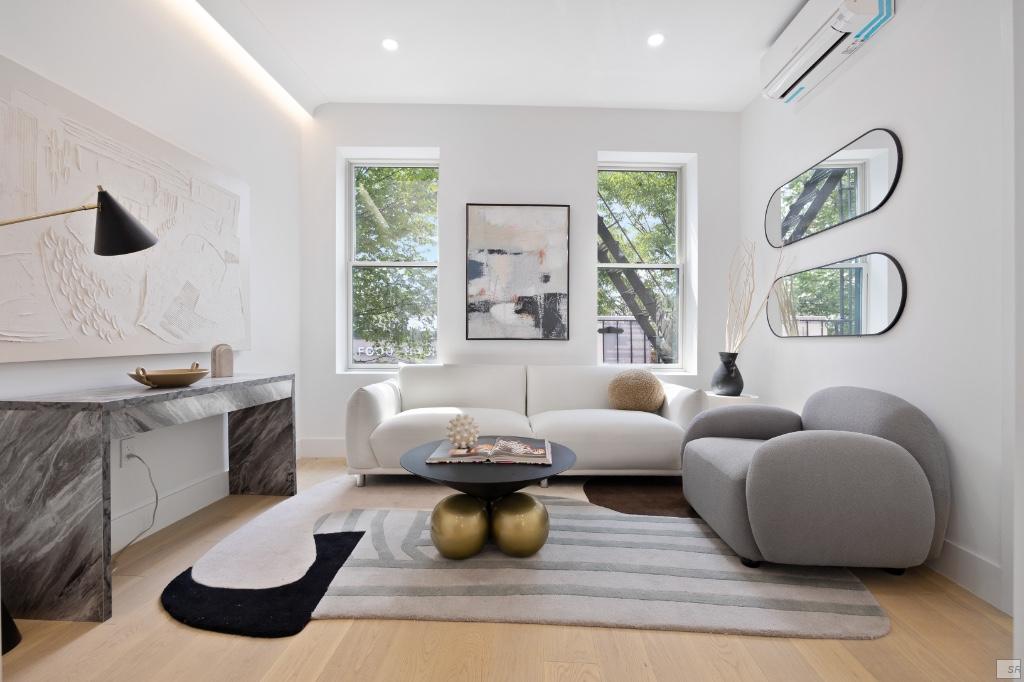 a living room with furniture and a large window