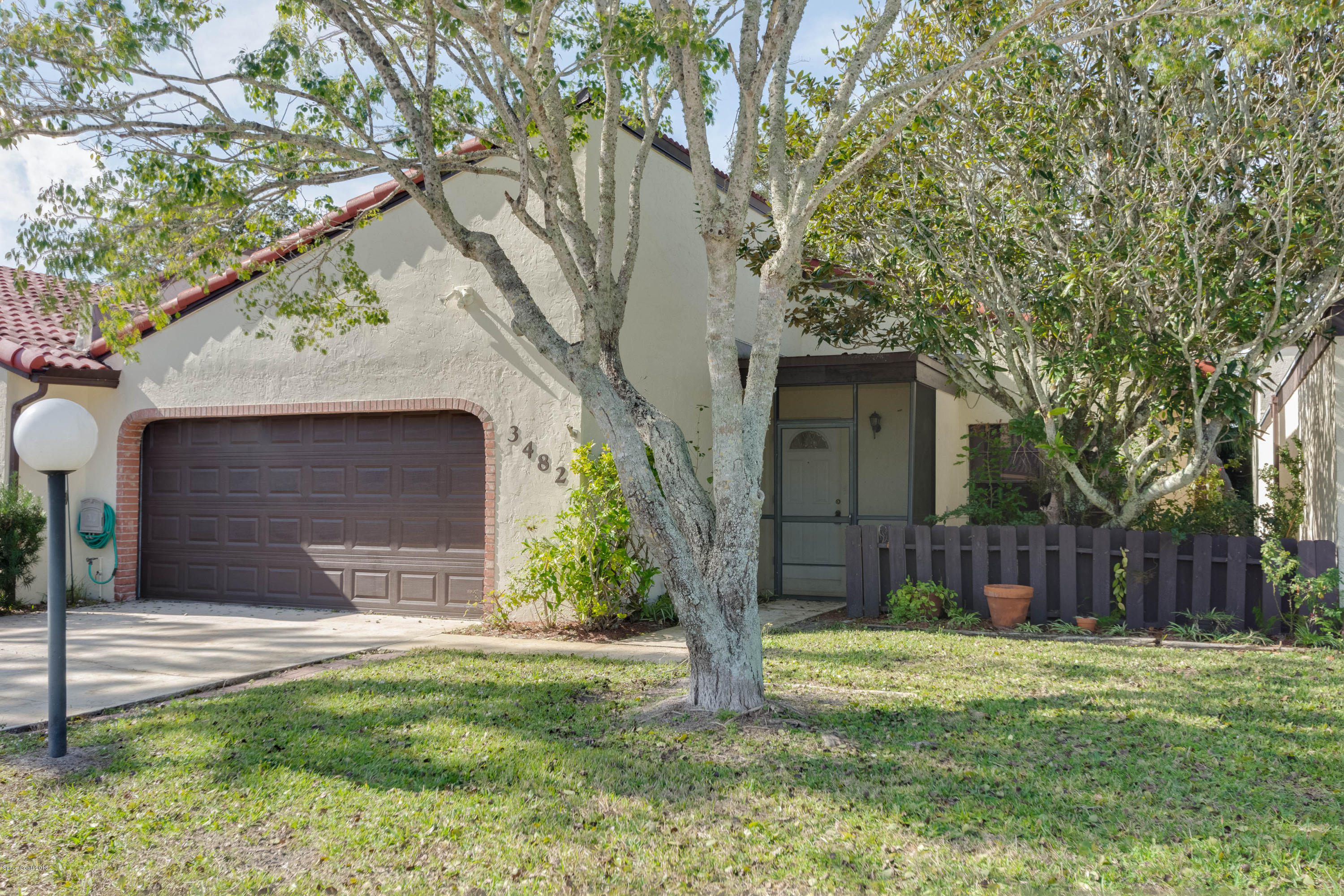 a house with a tree in front of the house