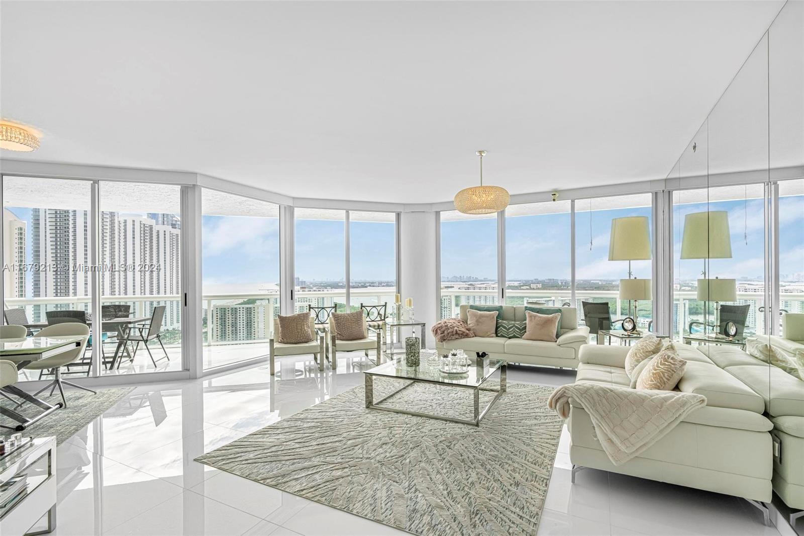 a living room with furniture and large windows