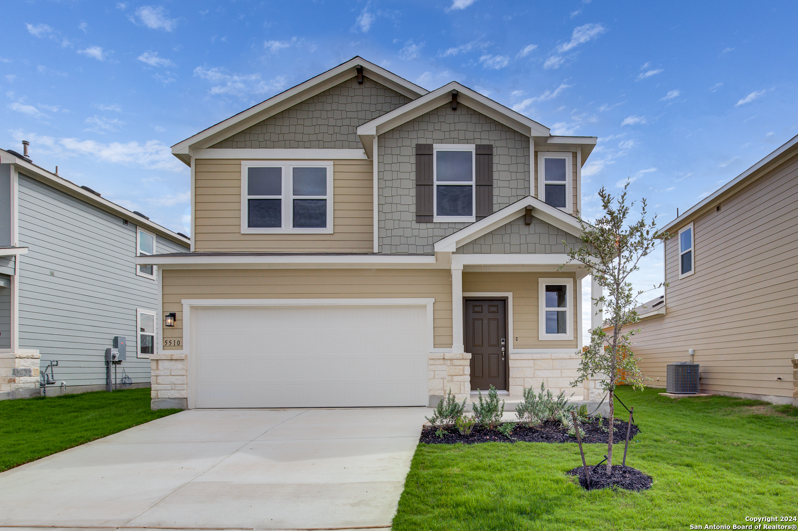 a front view of a house with a yard and garage