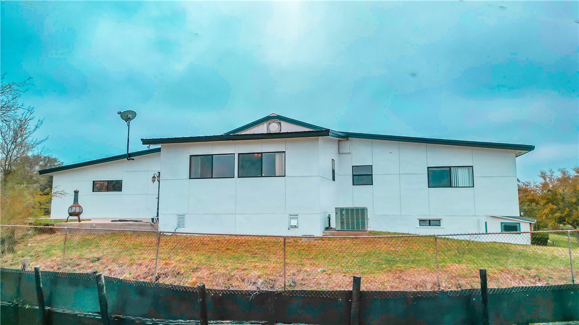 a view of a house with swimming pool next to a yard