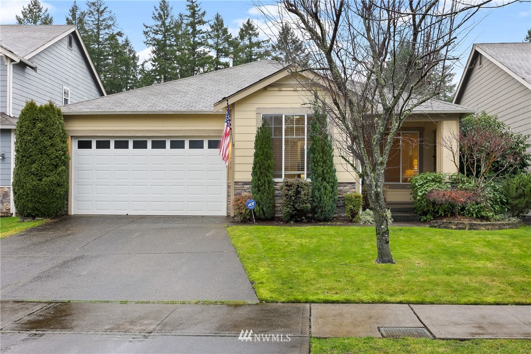 a front view of a house with a yard and garage