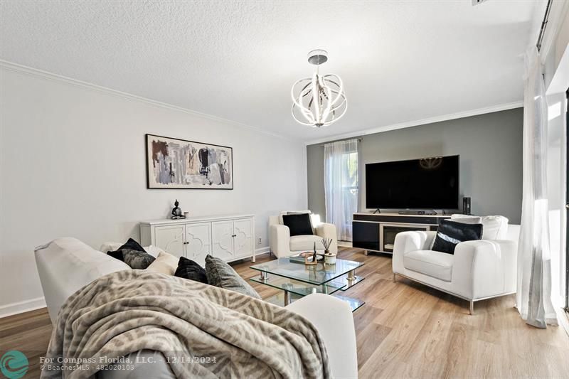 a bedroom with furniture and a flat screen tv