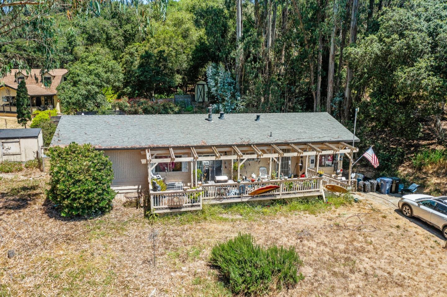 an aerial view of a house with garden space and boat