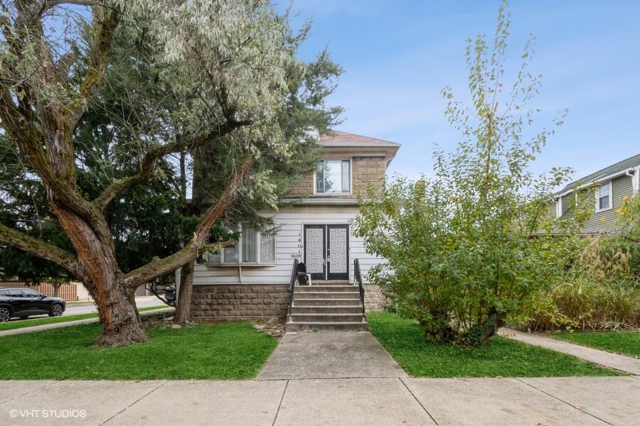 a front view of a house with garden