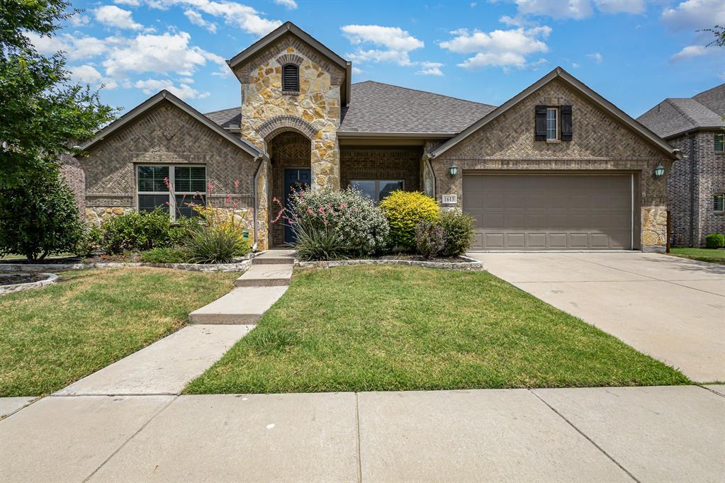 a front view of a house with garden