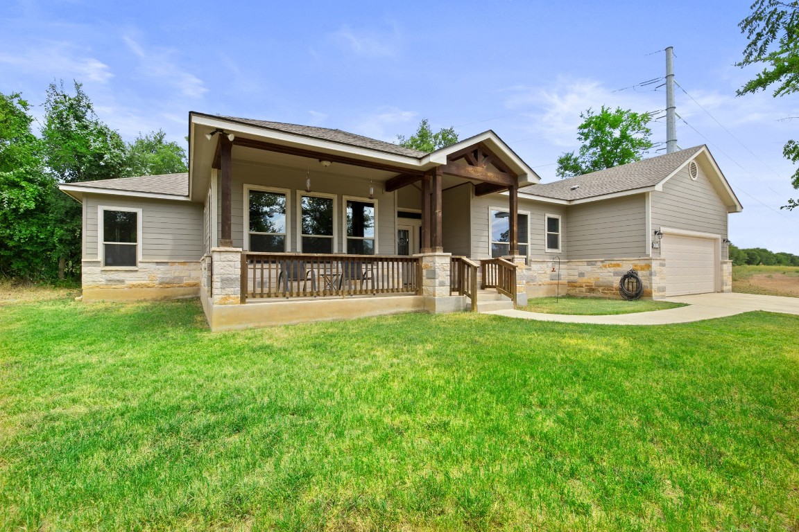 a front view of house with yard and green space