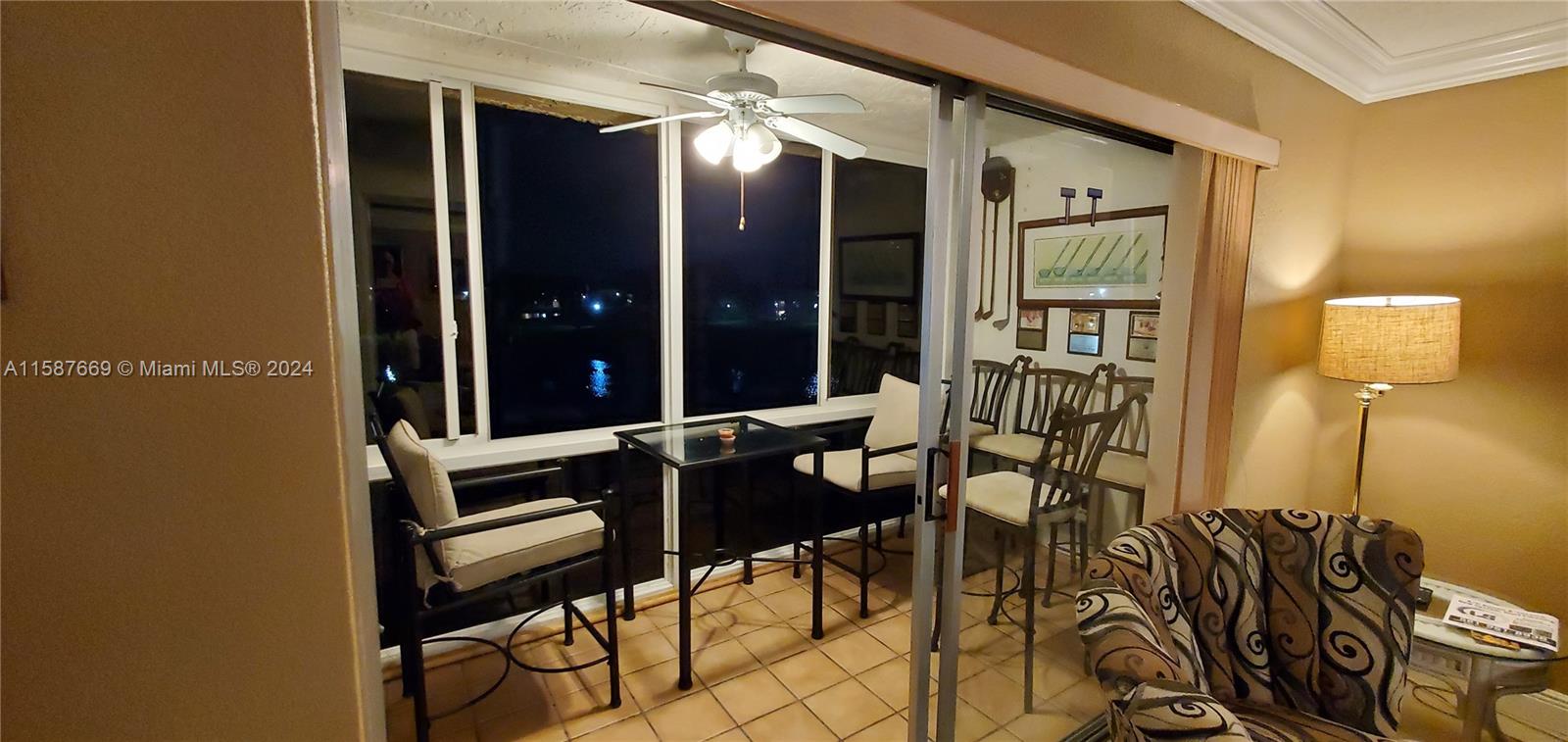 a balcony with table and chairs