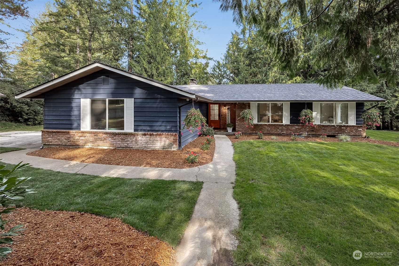 a front view of a house with yard and green space