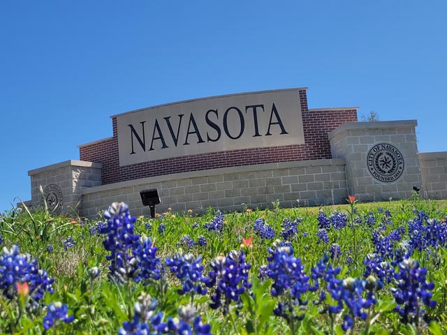 a sign that is in front of flowers