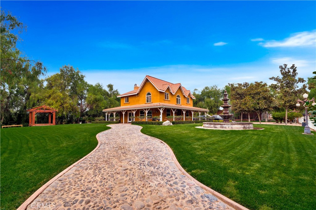 a view of a big house with a big yard