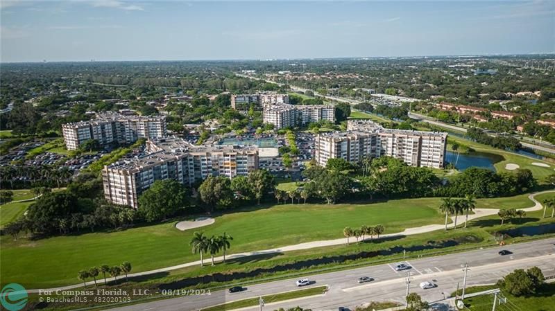 an aerial view of a city with lots of residential buildings and green space