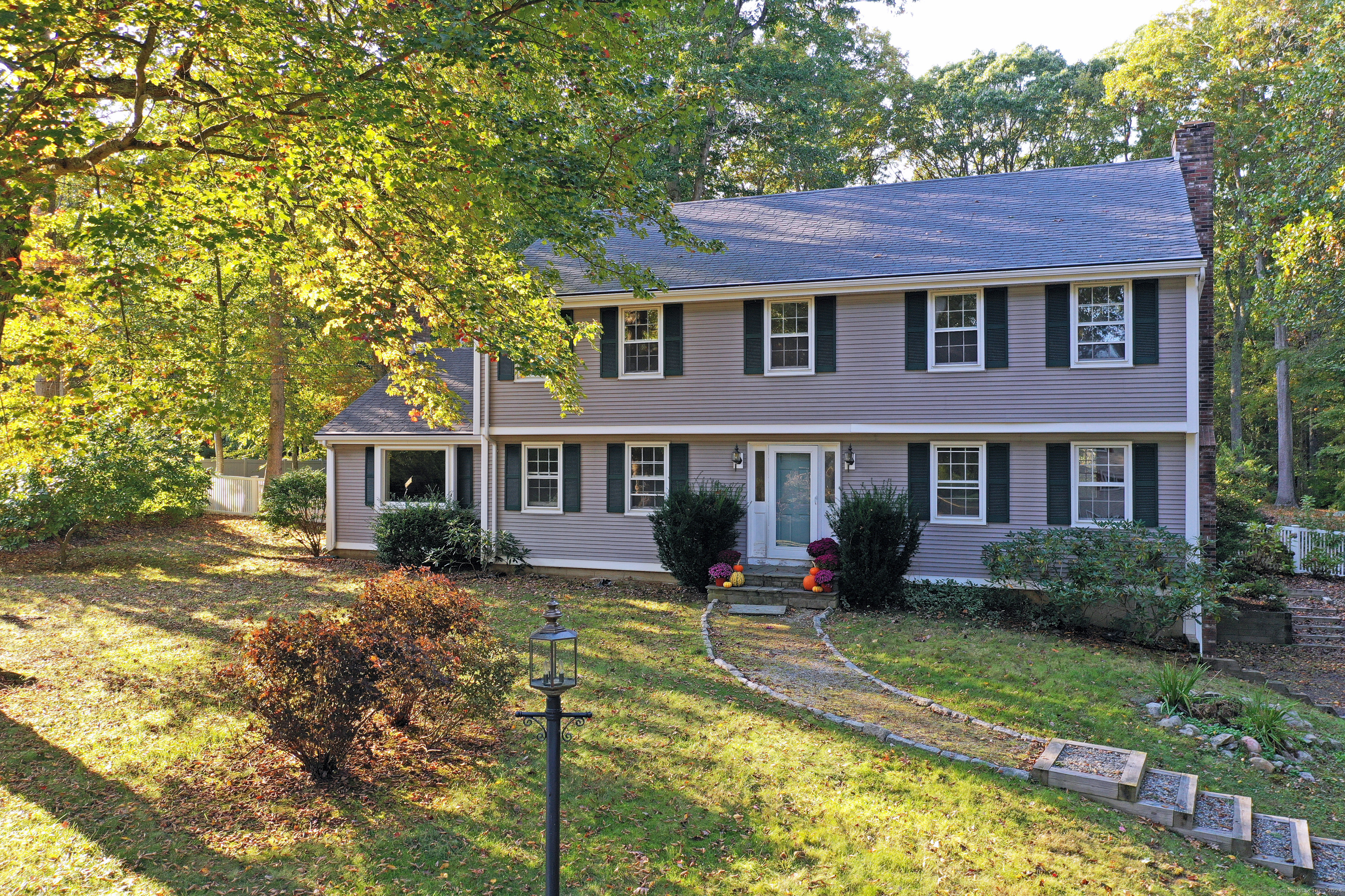 a front view of a house with yard porch and furniture