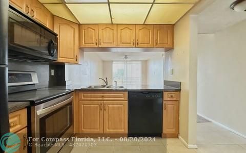 a kitchen with stainless steel appliances granite countertop a stove and a microwave