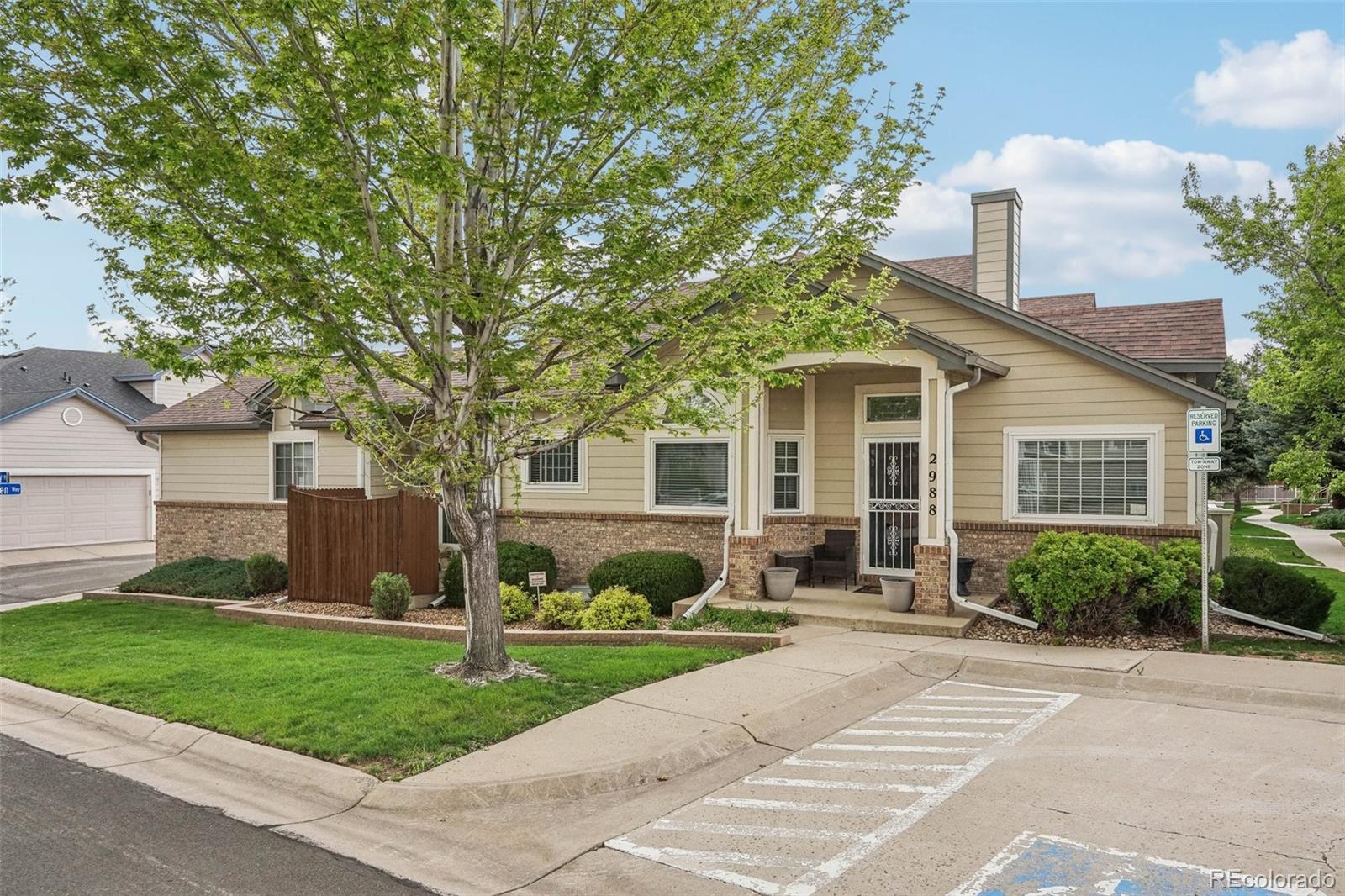 a front view of a house with a yard and potted plants