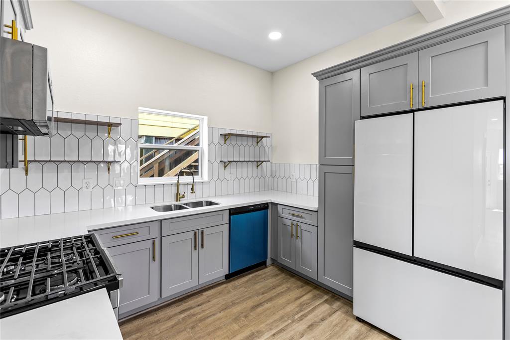 a kitchen with a refrigerator and a sink