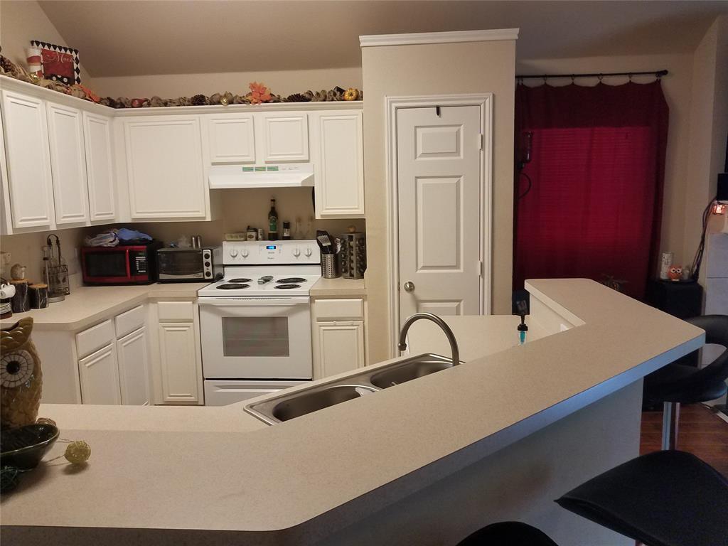 a kitchen with a stove a sink and a refrigerator