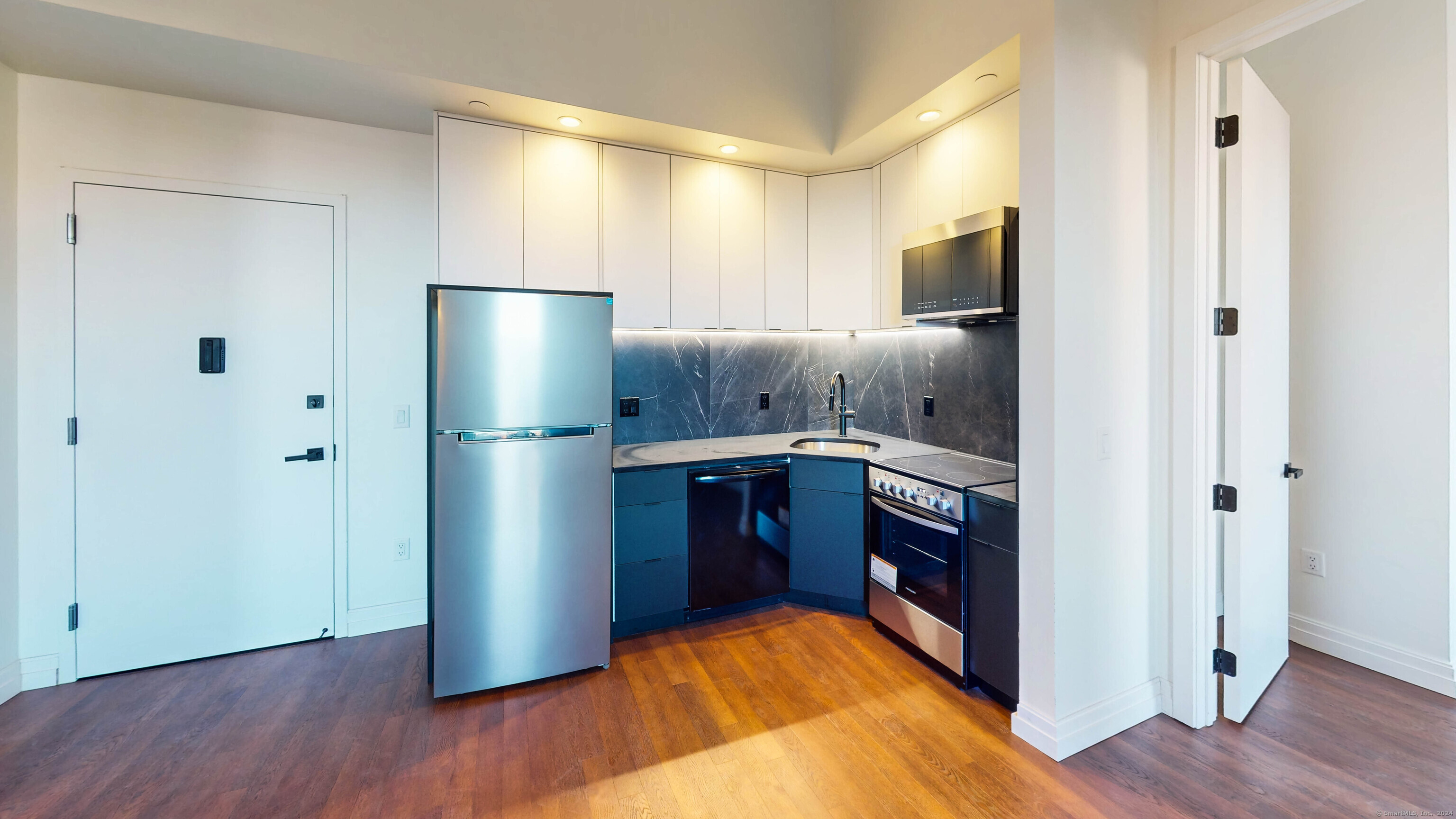 a kitchen with a refrigerator and a sink