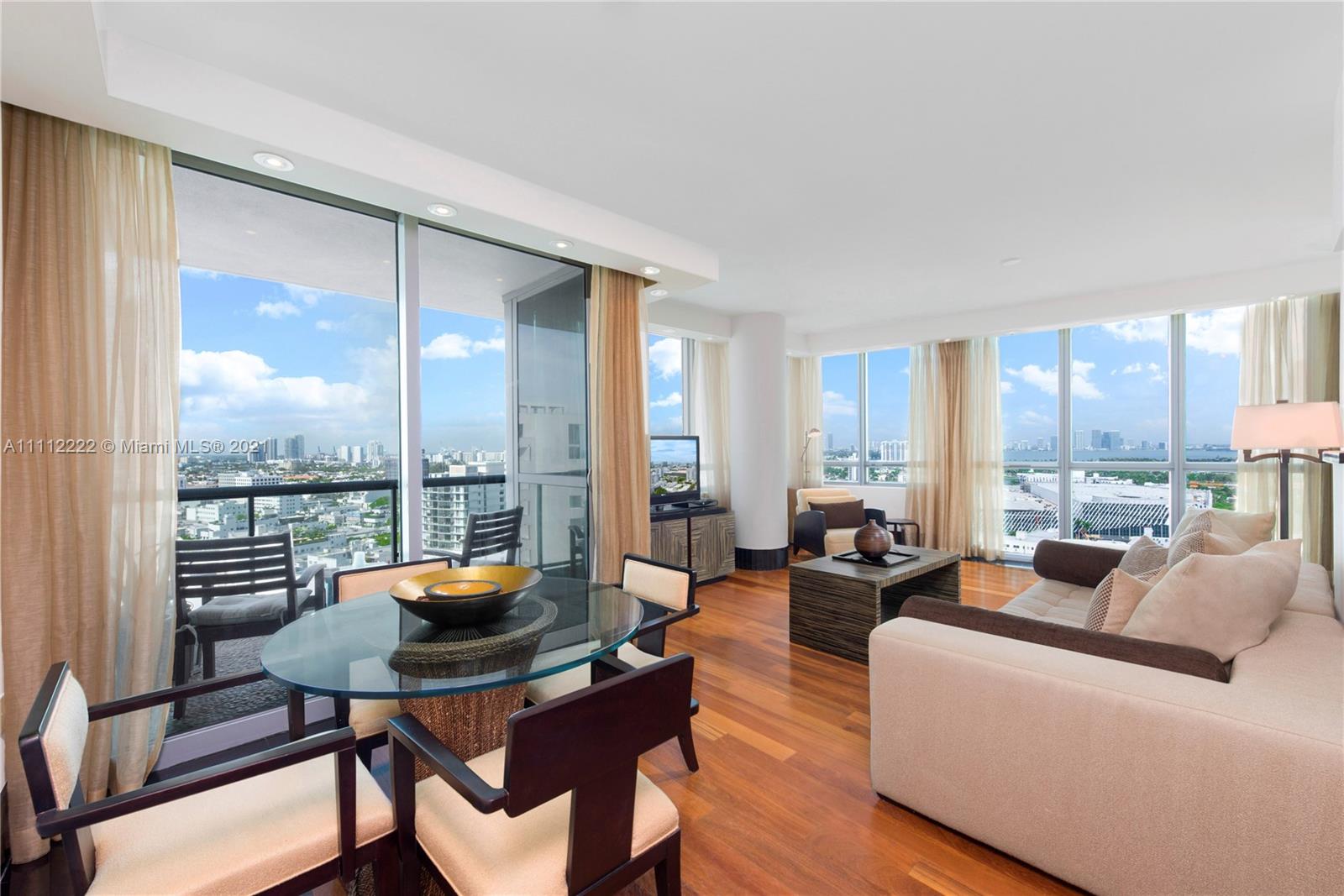 a living room with furniture and a floor to ceiling window