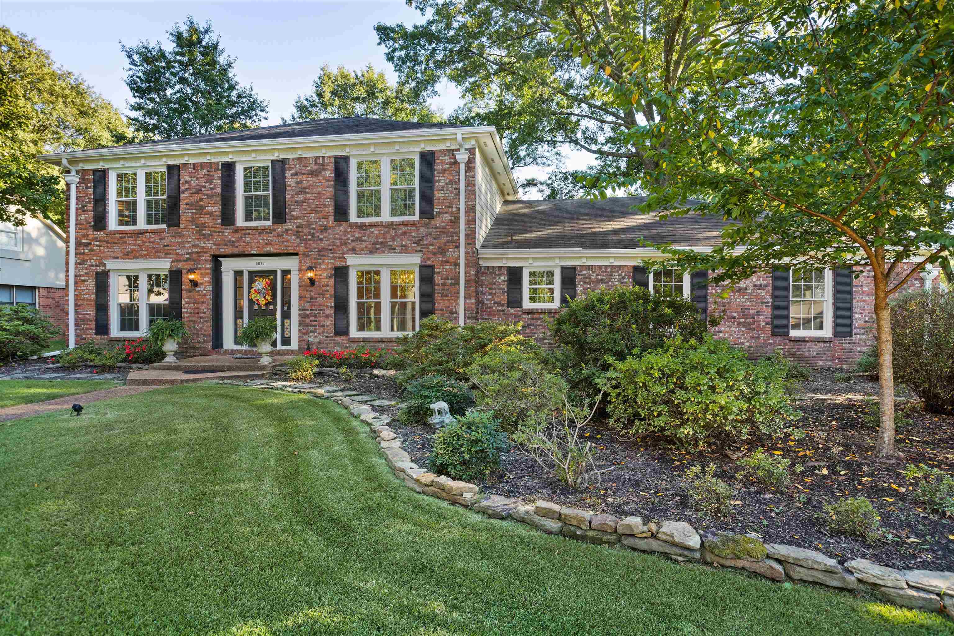 Colonial house featuring a front lawn