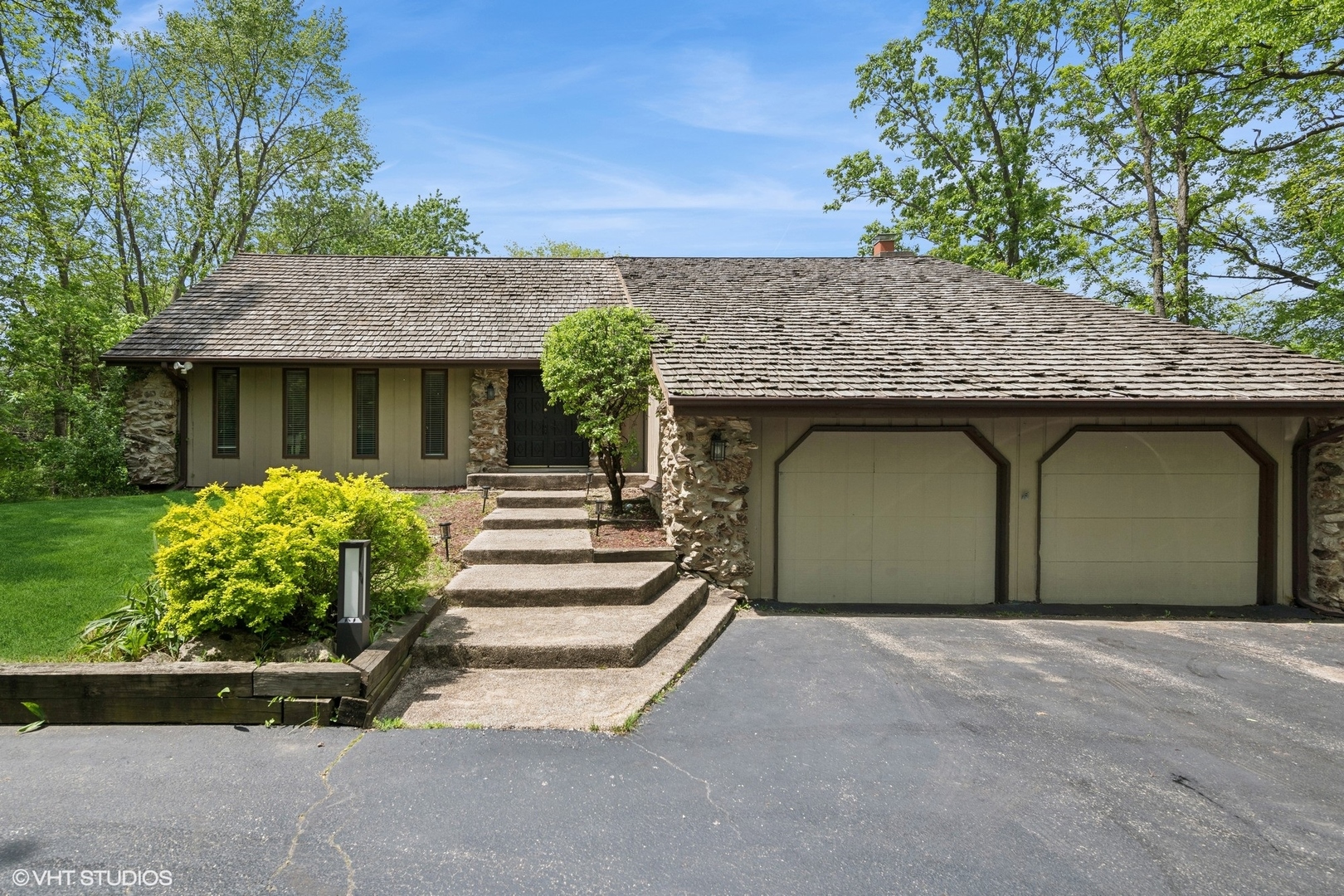 a front view of a house with a garden