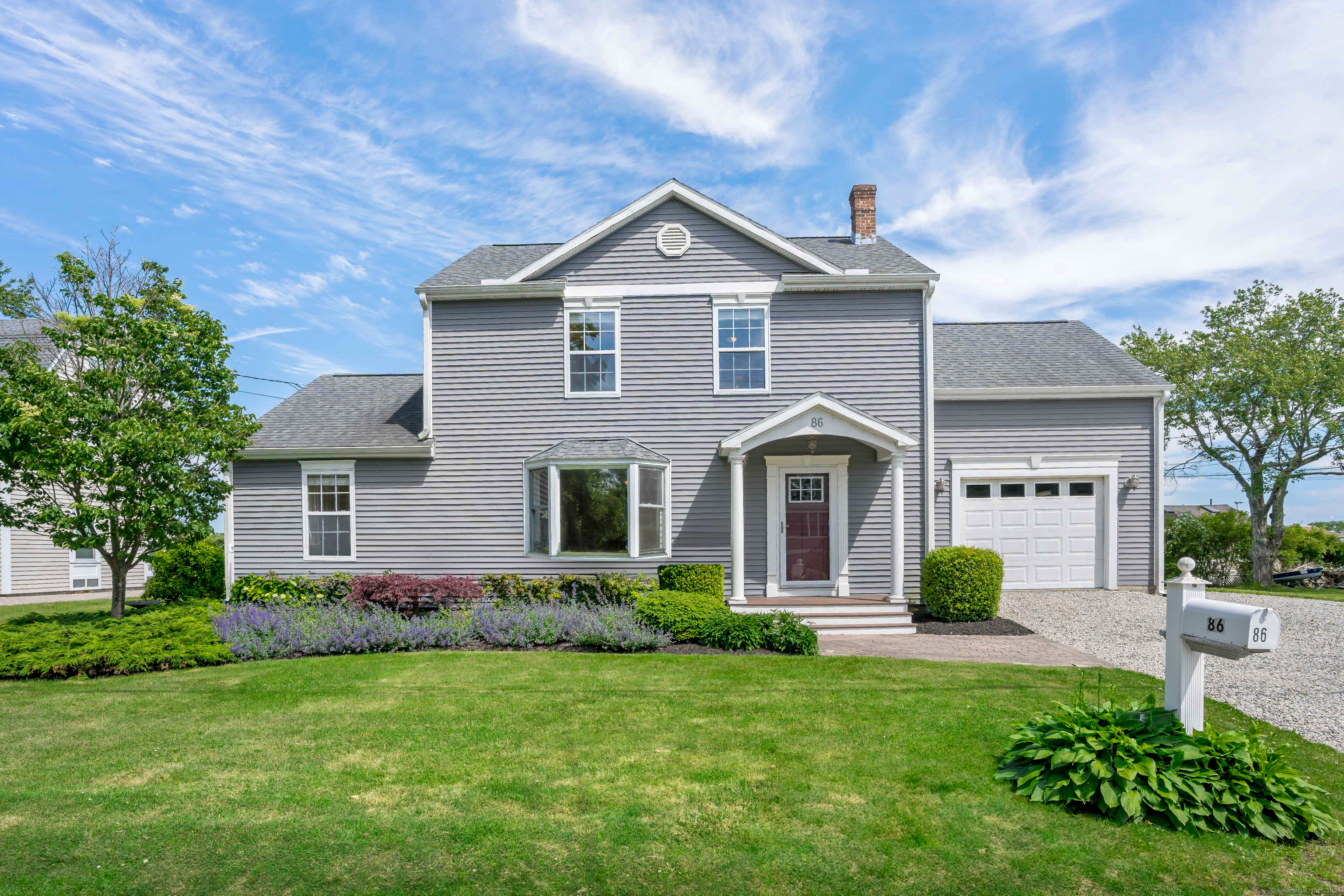 a front view of a house with garden