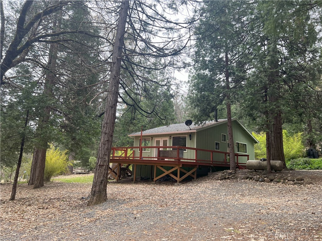 a view of a house with a yard and sitting area