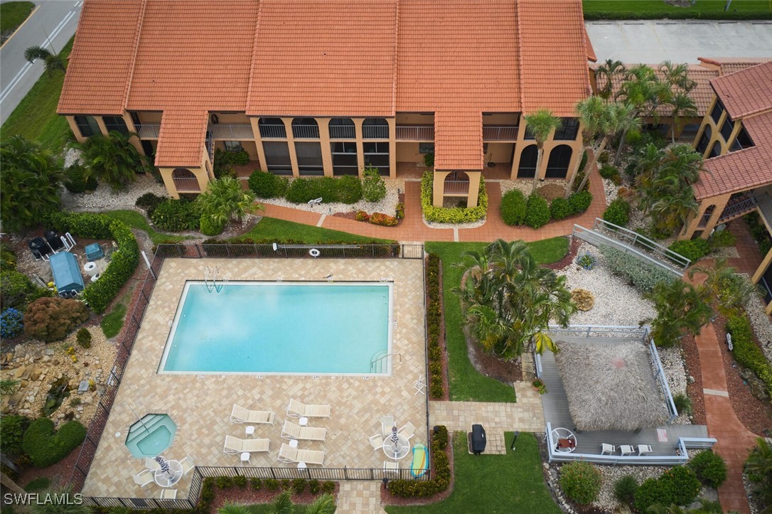 an aerial view of a house with residential space and swimming pool