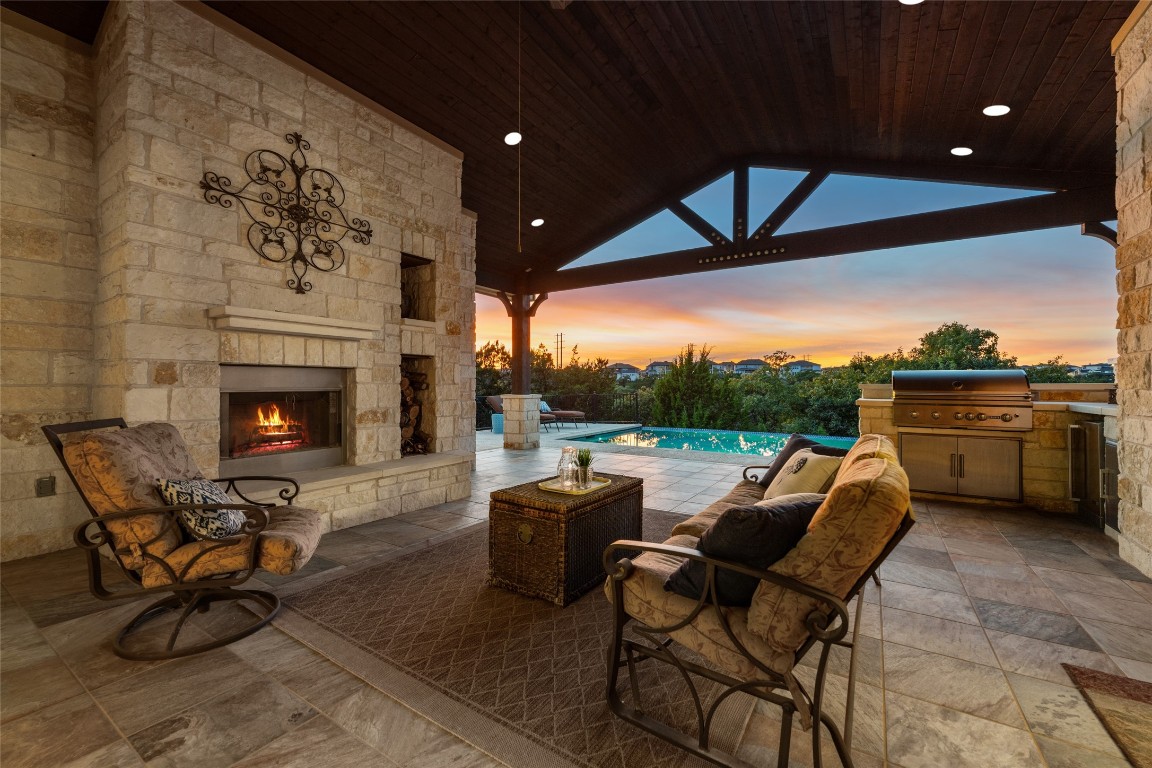 a outdoor living space with patio furniture and a fireplace