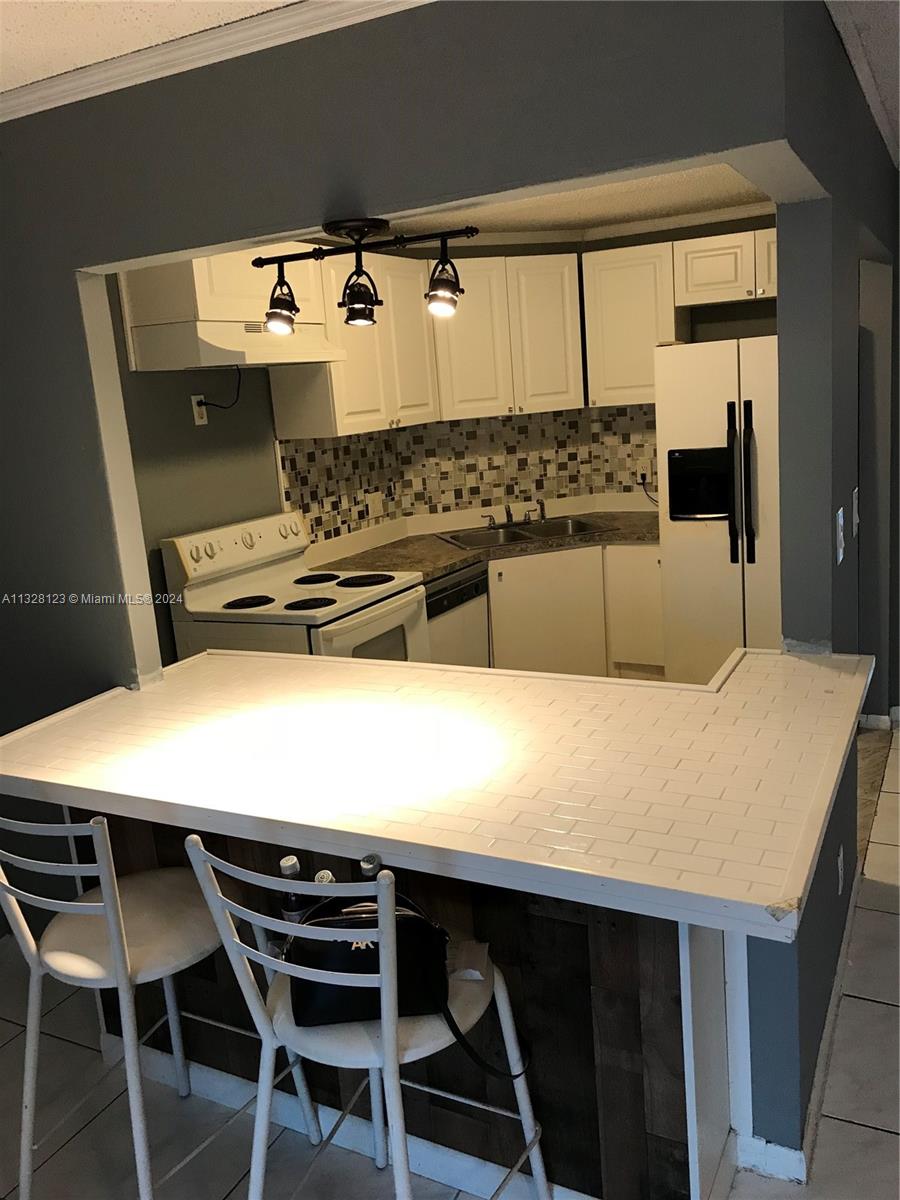 a kitchen with a table and chairs