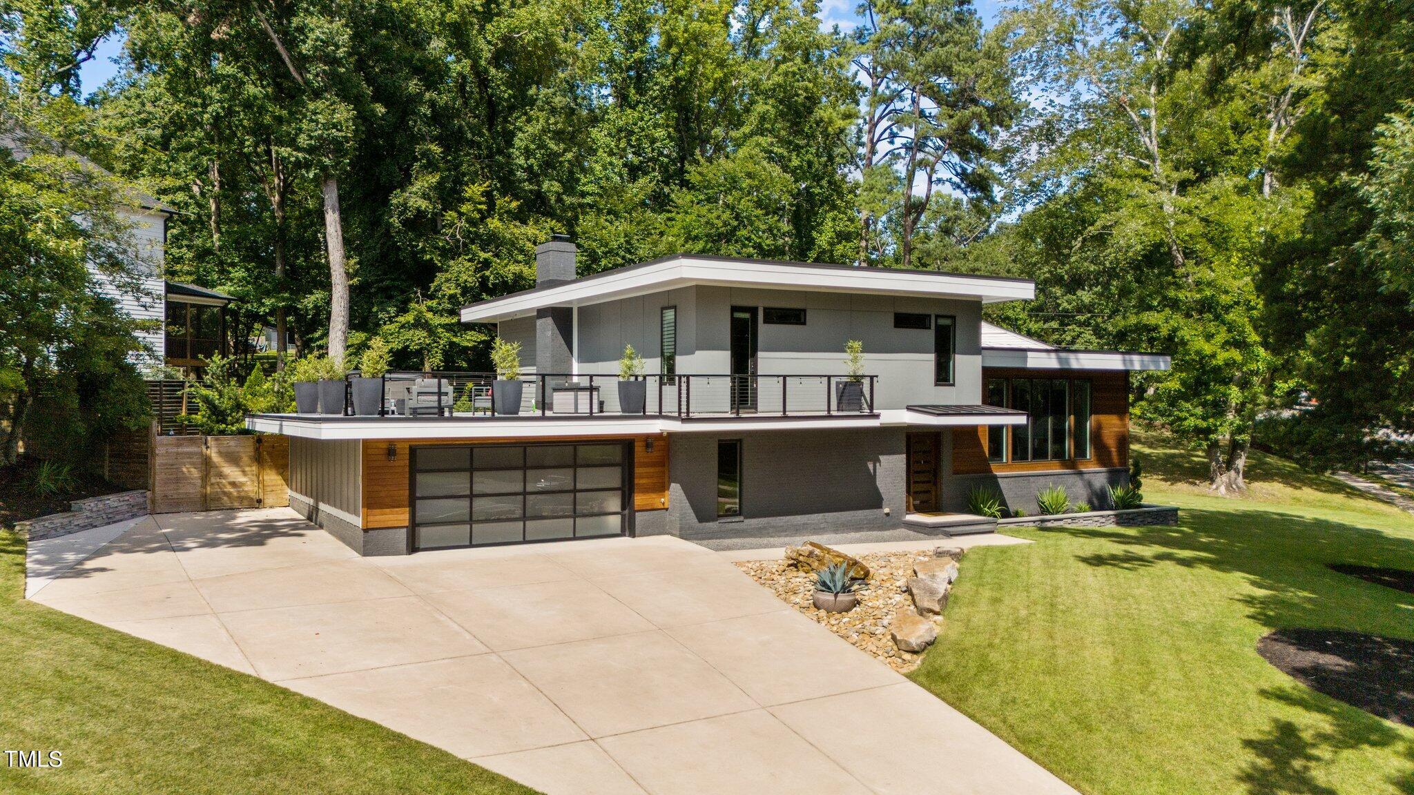 a view of a house with pool and chairs