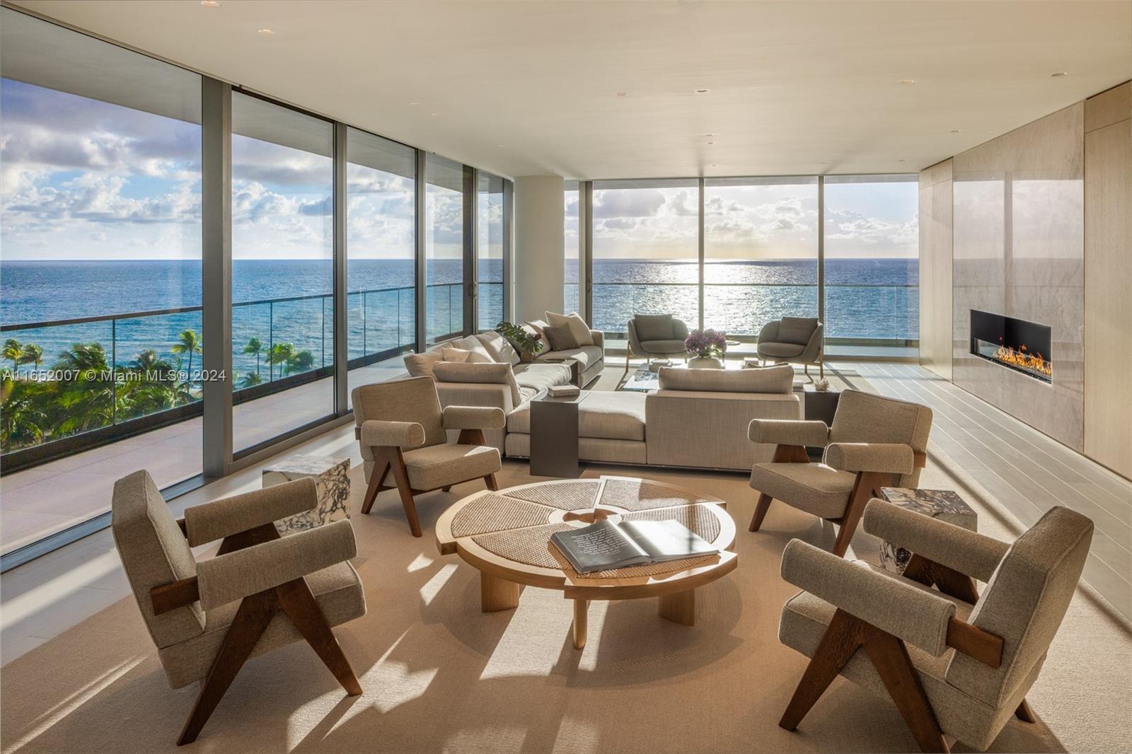 a living room with furniture large windows and a table