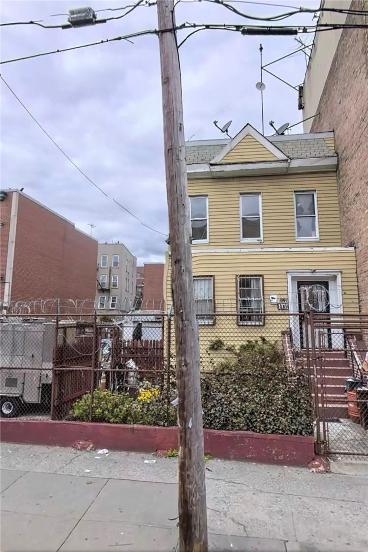 a front view of a house with a garden and plants