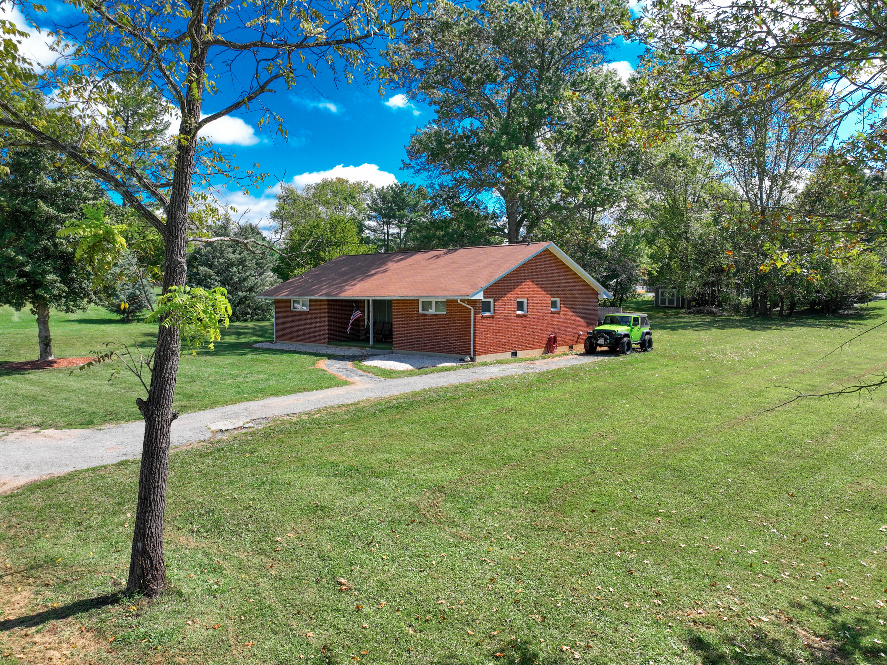 a house view with garden space and trees